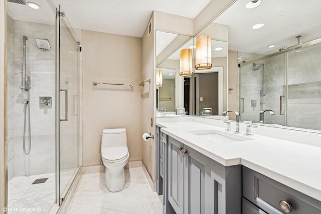 bathroom featuring vanity, toilet, and an enclosed shower