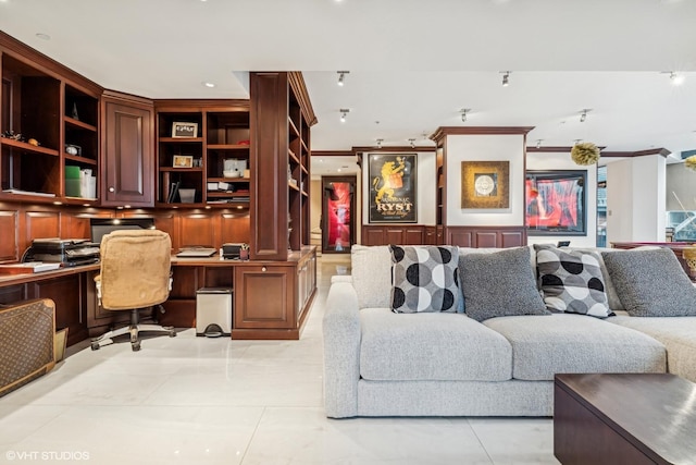 interior space with crown molding and built in desk