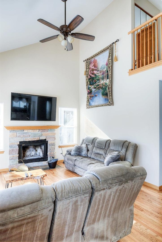 living room featuring wood-type flooring, lofted ceiling, ceiling fan, and a fireplace