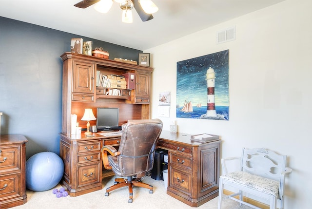 carpeted office space with ceiling fan