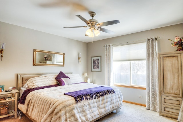 bedroom featuring ceiling fan and light carpet