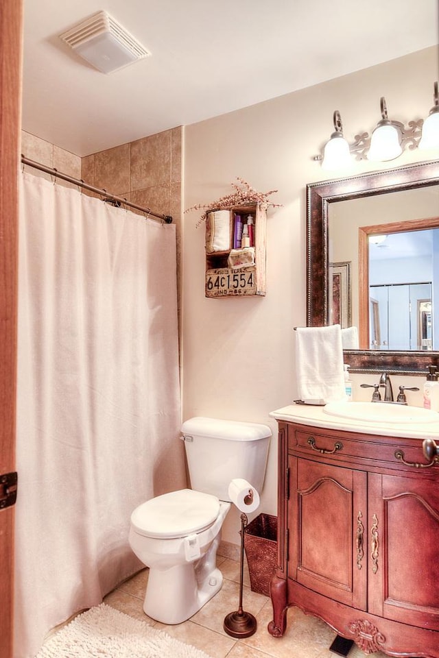 bathroom featuring vanity, toilet, curtained shower, and tile patterned flooring