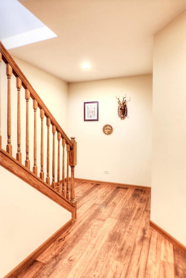 stairs featuring wood-type flooring