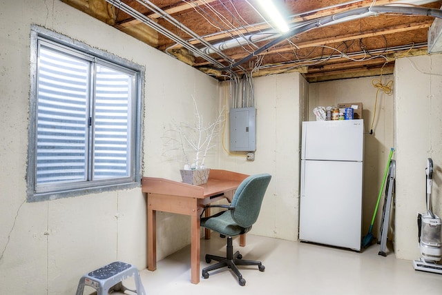 office area with concrete flooring and electric panel