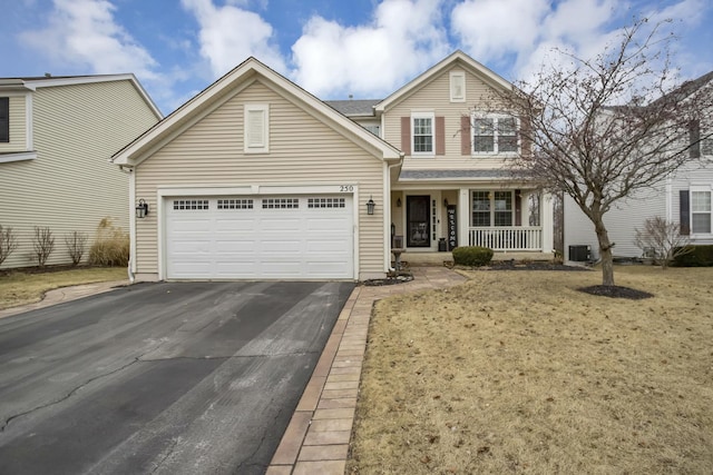 traditional-style house featuring driveway, a garage, a porch, a front lawn, and central AC