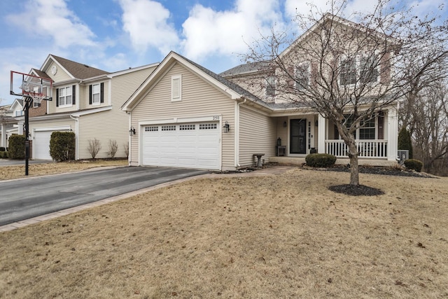 view of front facade featuring an attached garage, driveway, and a front yard