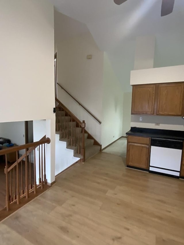 kitchen featuring dishwasher, high vaulted ceiling, ceiling fan, and light wood-type flooring