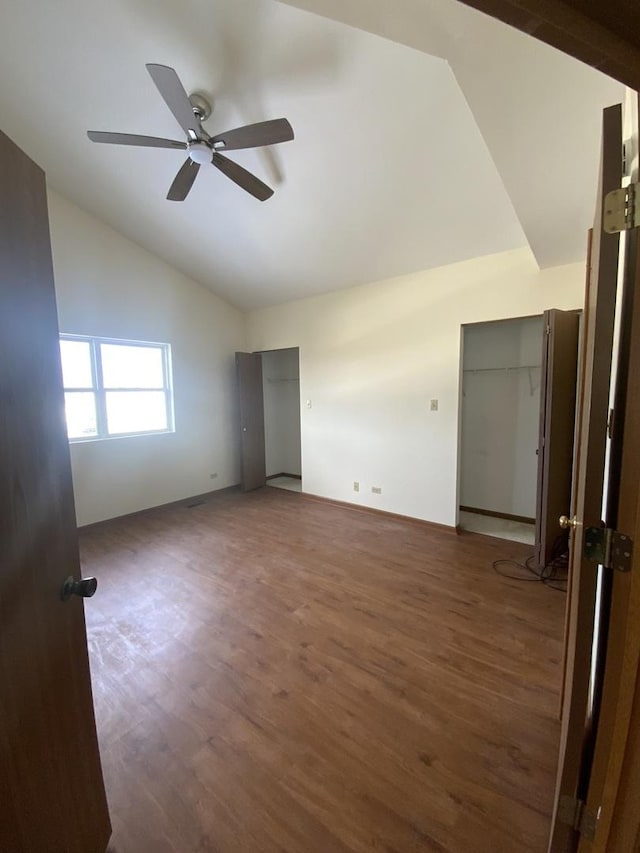 spare room featuring ceiling fan, dark hardwood / wood-style floors, and high vaulted ceiling