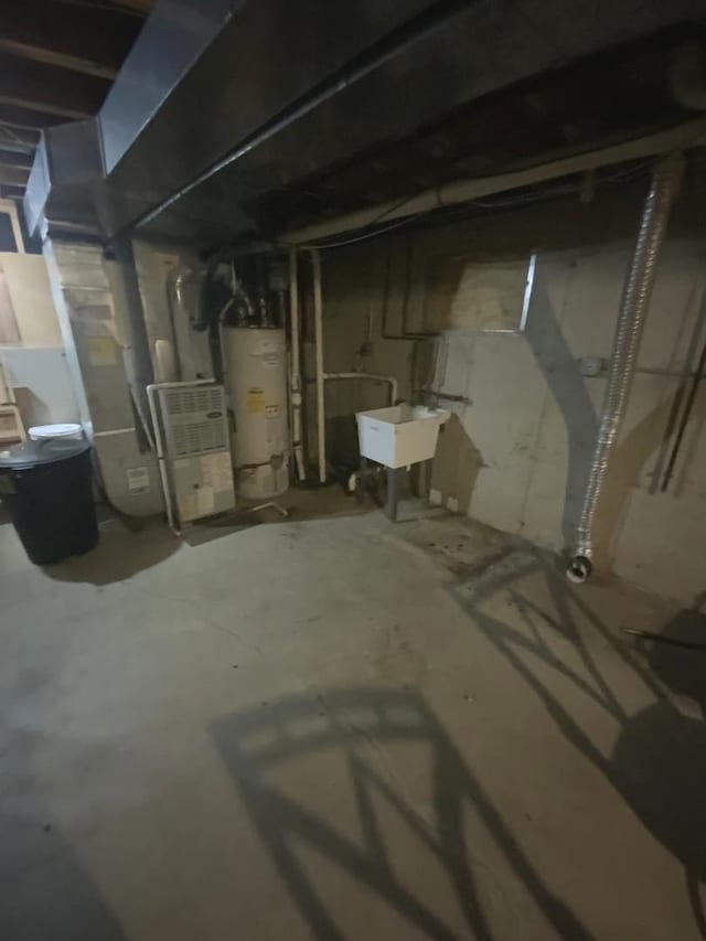 basement featuring sink and water heater