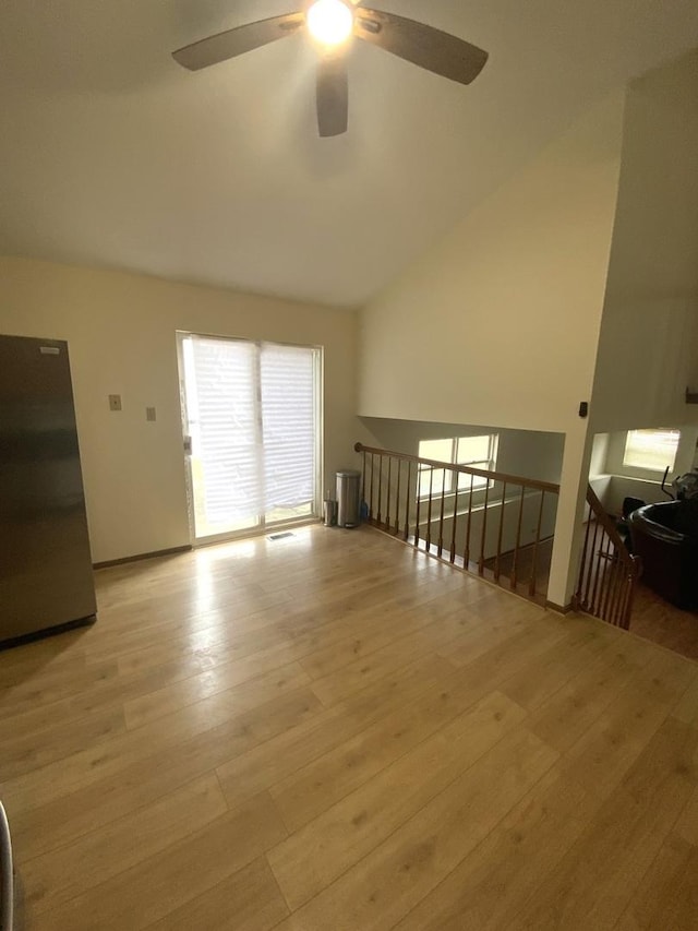 interior space featuring vaulted ceiling and light hardwood / wood-style flooring