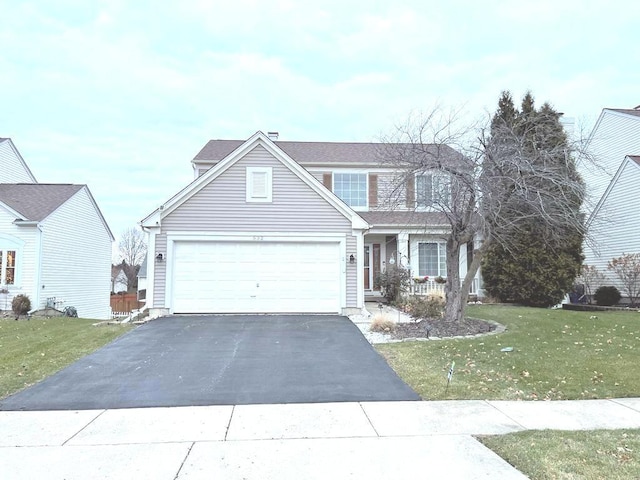 view of front of property featuring a garage and a front lawn