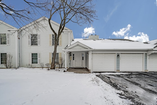 view of front of home with central AC unit and a garage