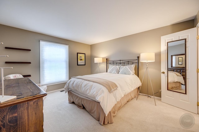 bedroom featuring light carpet