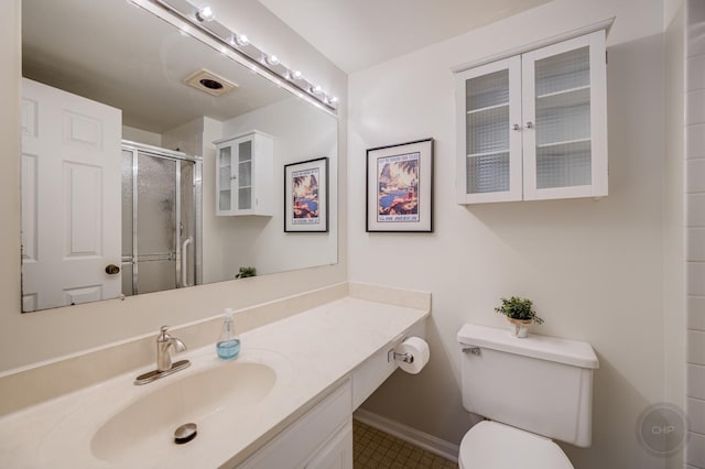 bathroom with an enclosed shower, vanity, and toilet