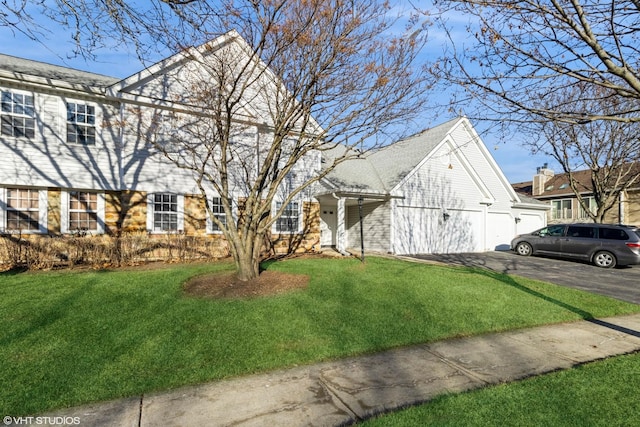 view of front of house with a garage and a front lawn