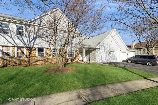 view of front of property with a garage and a front lawn