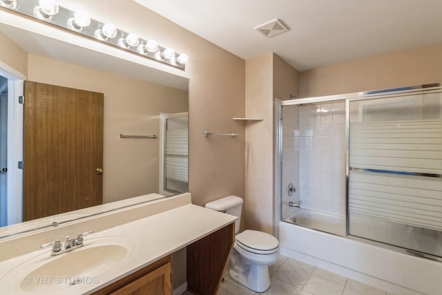 full bathroom with vanity, enclosed tub / shower combo, and toilet