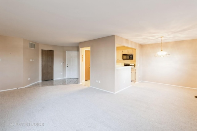 empty room featuring light colored carpet and a notable chandelier