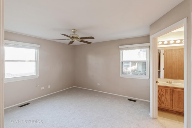 carpeted empty room with sink and ceiling fan