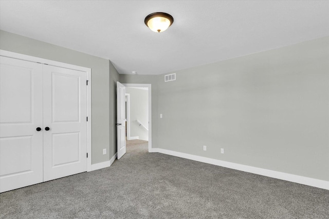 unfurnished bedroom with carpet floors and a closet