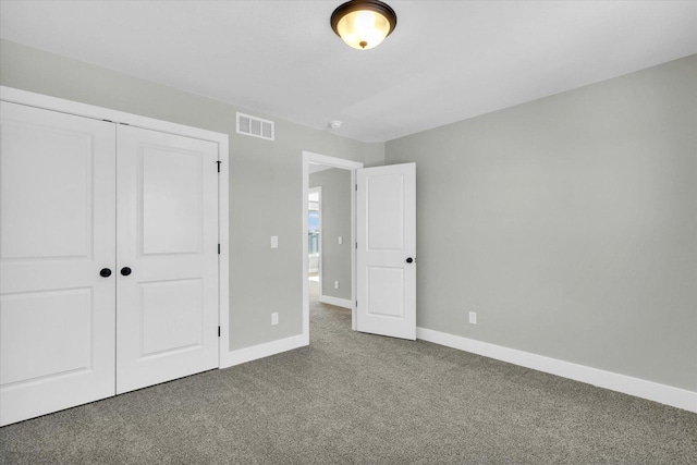 unfurnished bedroom featuring carpet floors and a closet