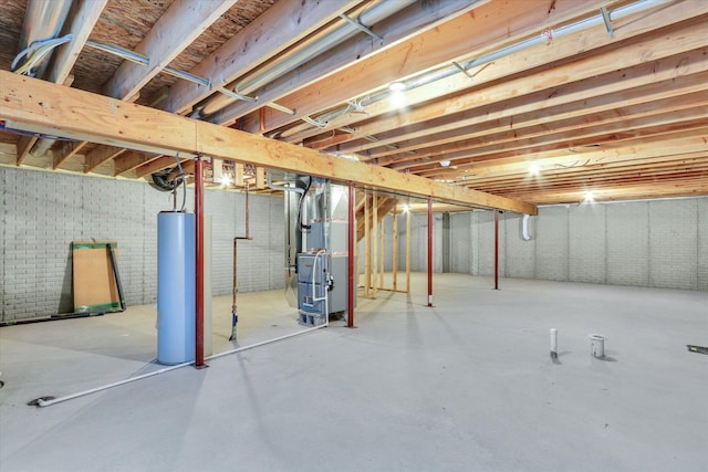 basement featuring heating unit, brick wall, and water heater