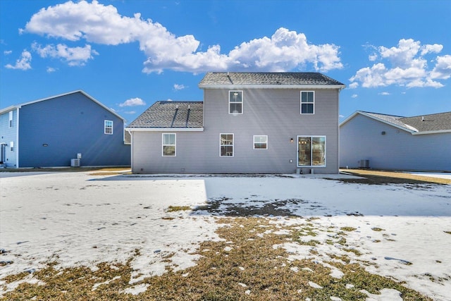 snow covered house with central AC