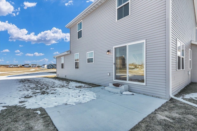 snow covered property featuring a patio area