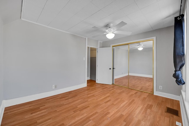 unfurnished bedroom with ceiling fan, light hardwood / wood-style floors, and a closet