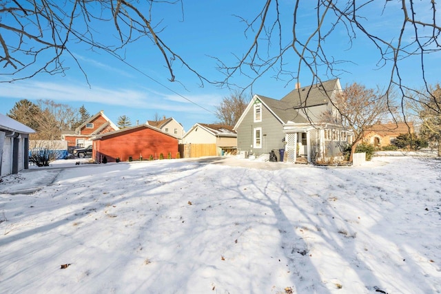 view of snow covered back of property