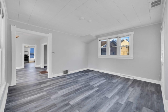 empty room featuring ornamental molding and dark hardwood / wood-style floors