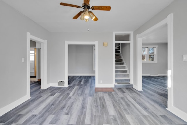 unfurnished living room with ceiling fan and light wood-type flooring