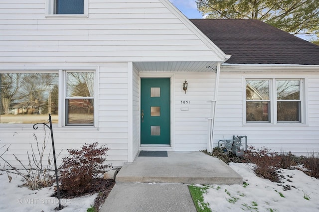 view of snow covered property entrance