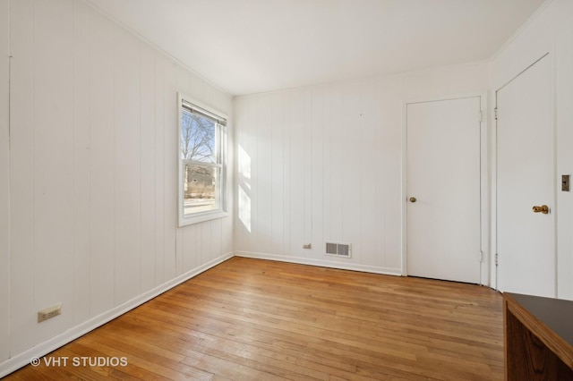 empty room with light hardwood / wood-style flooring