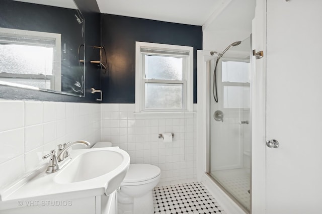 bathroom featuring tile walls, tile patterned flooring, vanity, an enclosed shower, and toilet