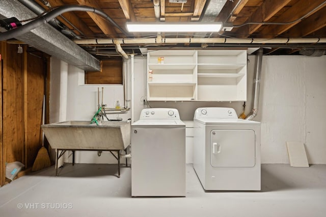 clothes washing area featuring independent washer and dryer and sink