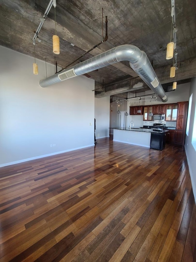 kitchen with sink, pendant lighting, and dark hardwood / wood-style flooring