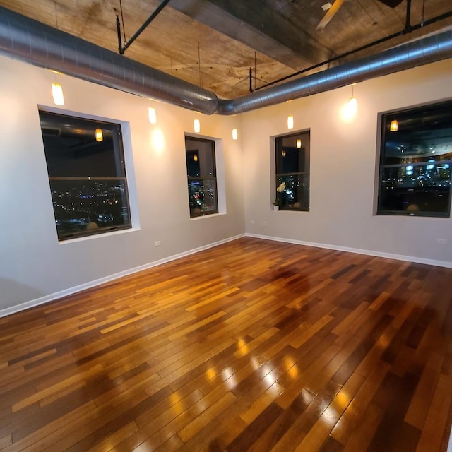 spare room featuring wood-type flooring