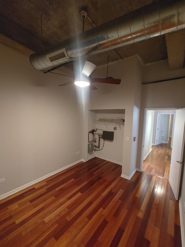 basement featuring ceiling fan and wood-type flooring