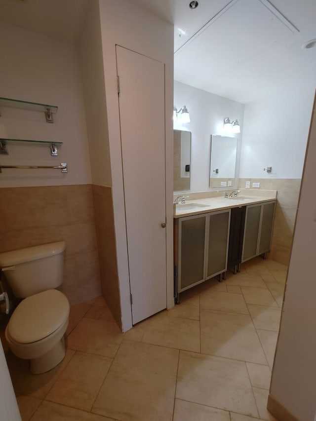 bathroom with vanity, tile walls, tile patterned floors, and toilet