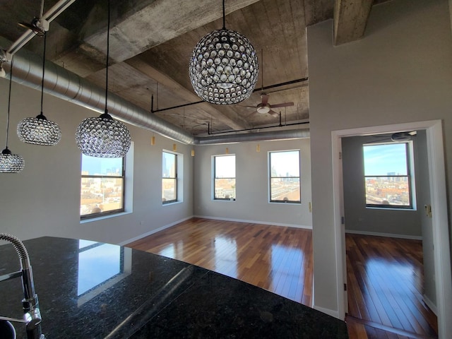 unfurnished dining area with hardwood / wood-style floors and plenty of natural light