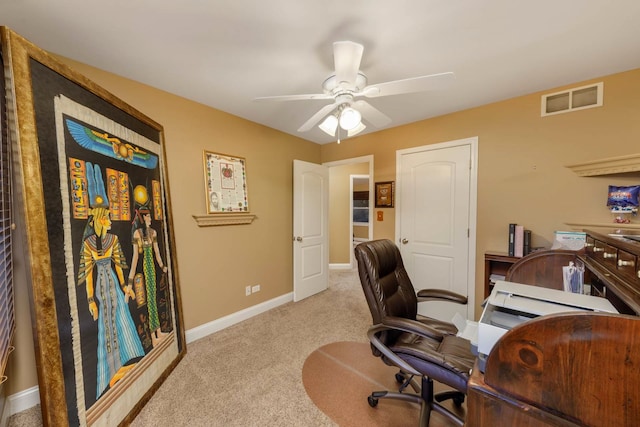 office space featuring light carpet and ceiling fan