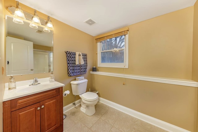 bathroom featuring vanity, tile patterned floors, and toilet