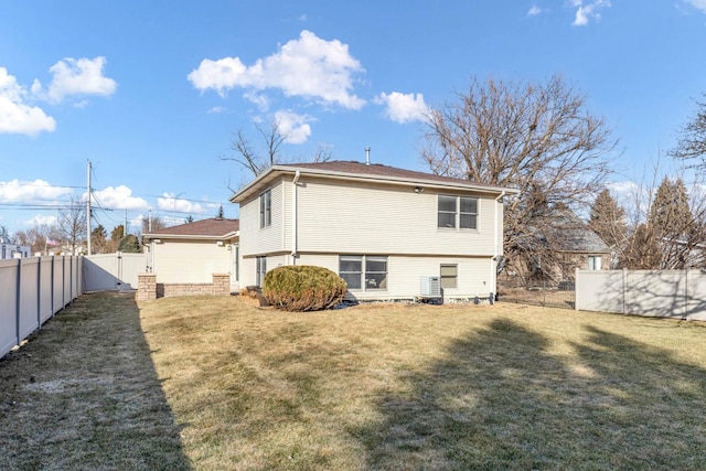 rear view of property featuring a yard