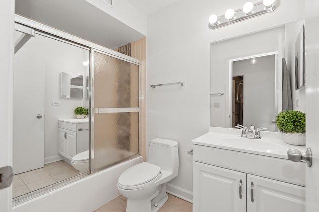 full bath featuring toilet, shower / bath combination with glass door, vanity, and tile patterned floors