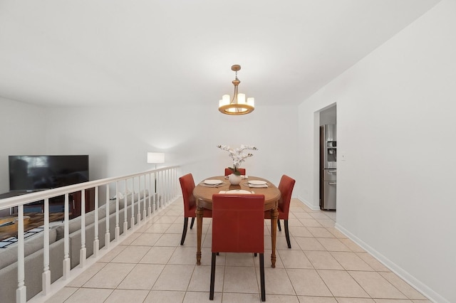 dining room featuring light tile patterned floors, baseboards, and an inviting chandelier