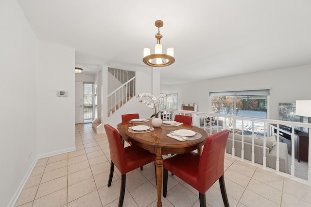 dining space featuring stairs, light tile patterned flooring, and baseboards