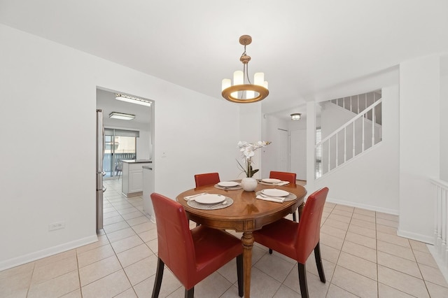 dining room with light tile patterned floors, stairway, baseboards, and an inviting chandelier