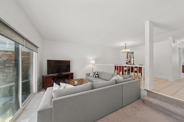 living area featuring baseboards and a chandelier