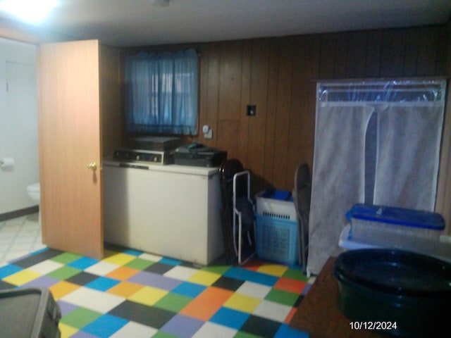 laundry area with wooden walls